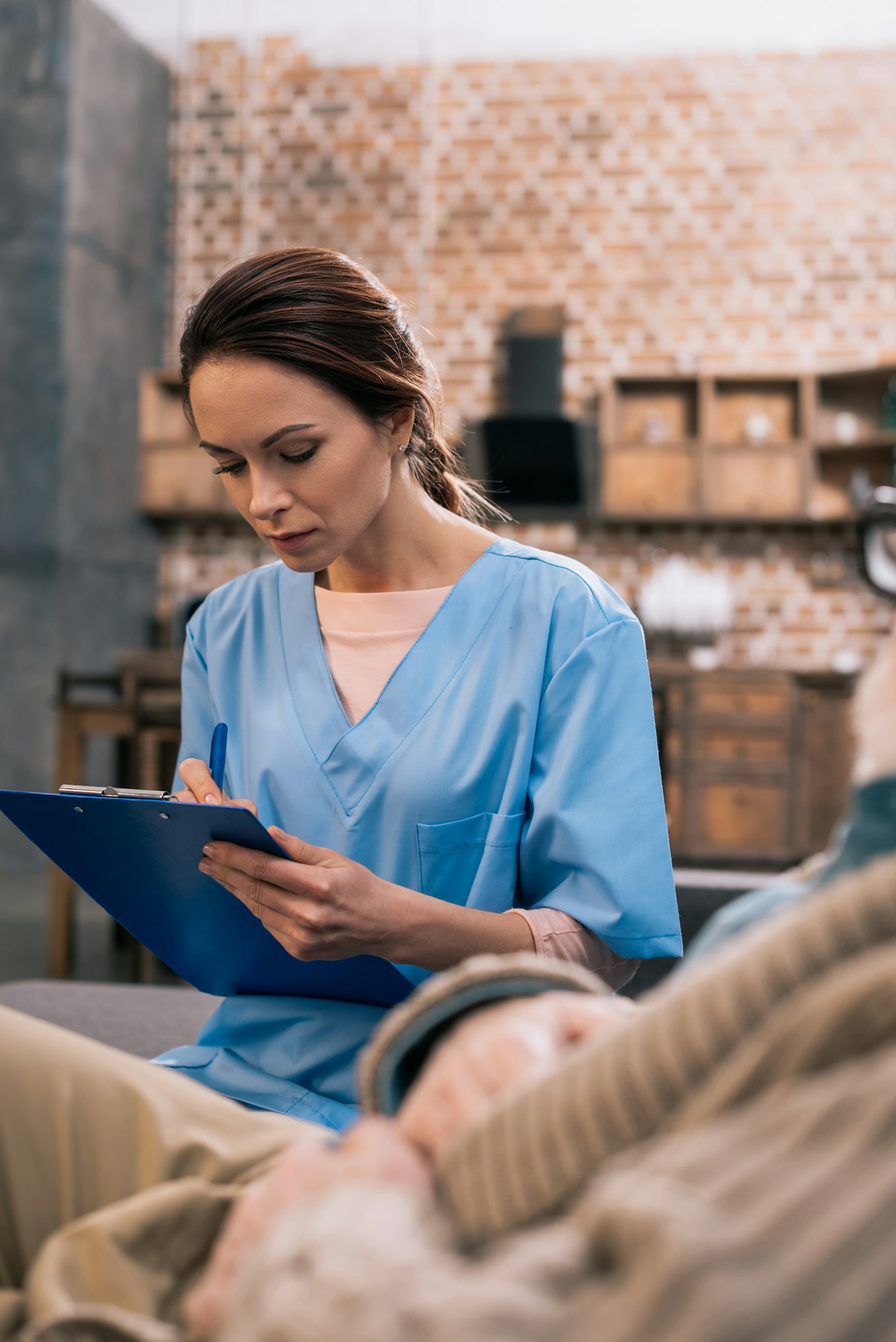 Nurse writing down medical complaints on clipboard